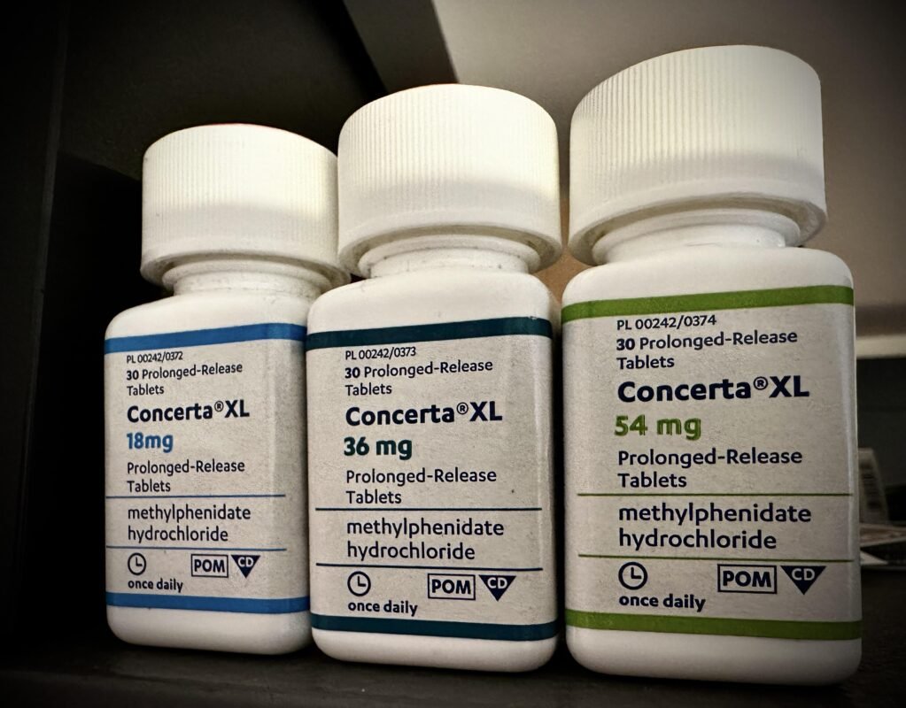 A person holding a box of Concerta (Methylphenidate) 18mg, representing safe online purchase options in New York City.